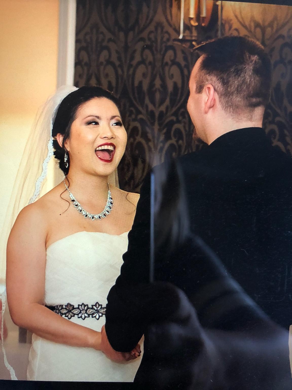 A sweet photo of a groom and a happy bride with beautiful glam makeup