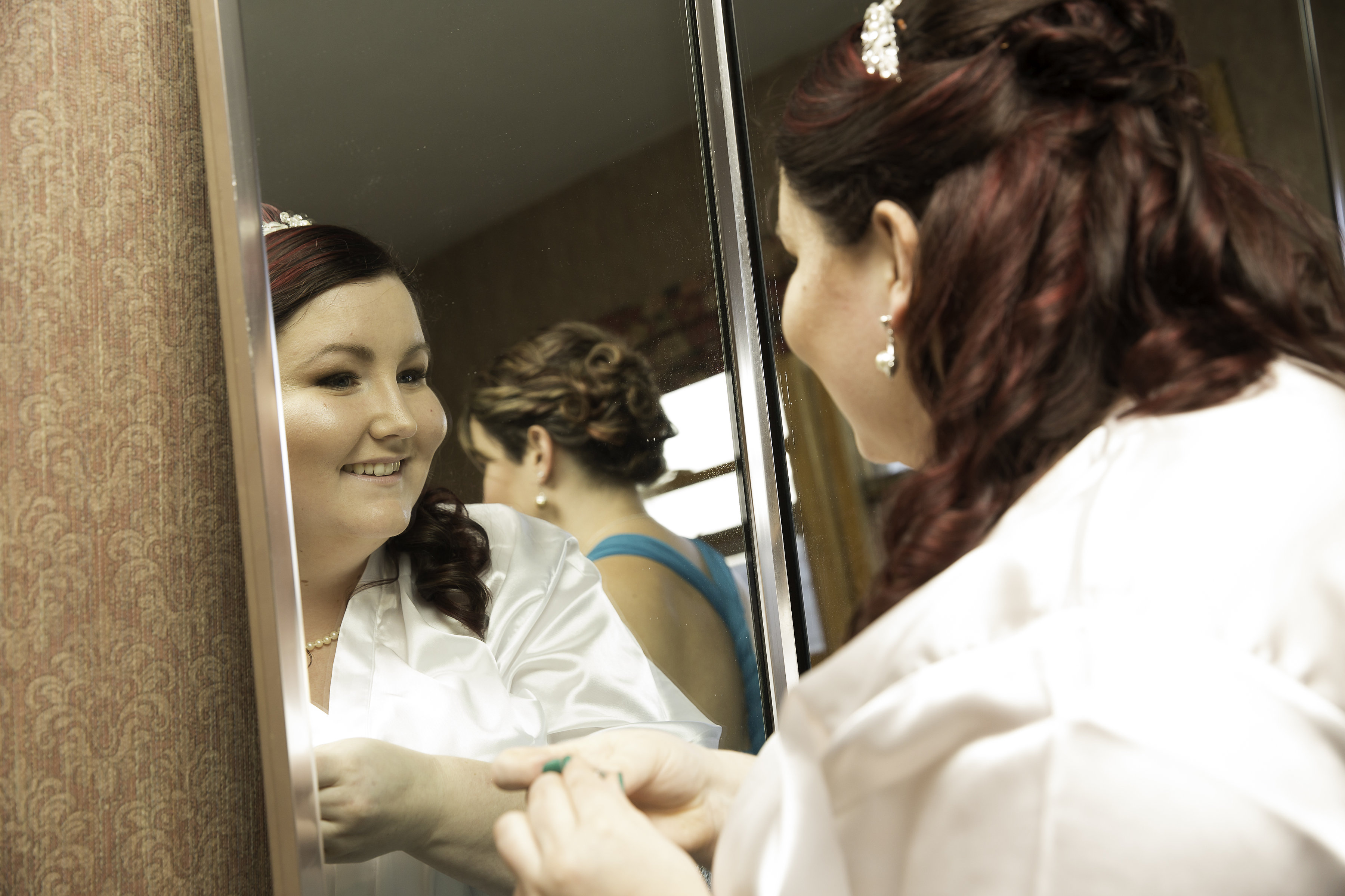 A beautiful bride looking at gorgeous makeup in mirror